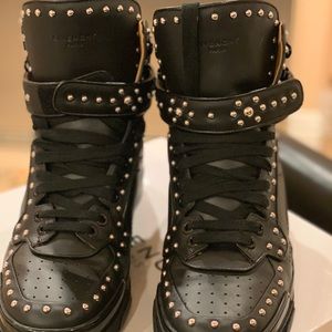 Givenchy studded high top black sneakers.